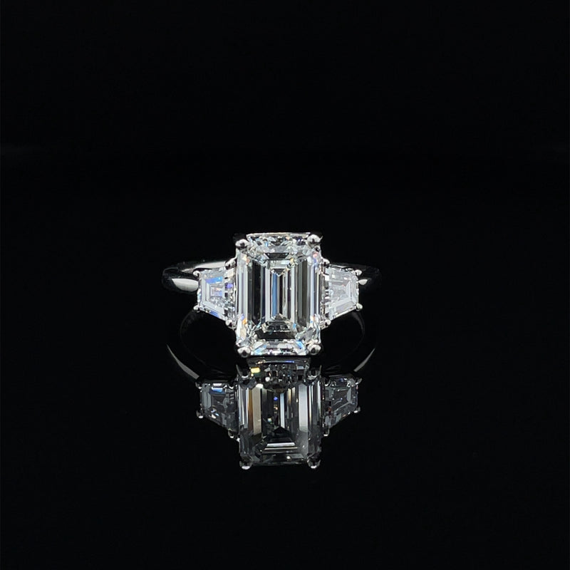 EMERALD CUT TRAPEZOID TRILOGY ENGAGEMENT RING