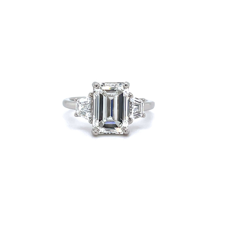 EMERALD CUT TRAPEZOID TRILOGY ENGAGEMENT RING