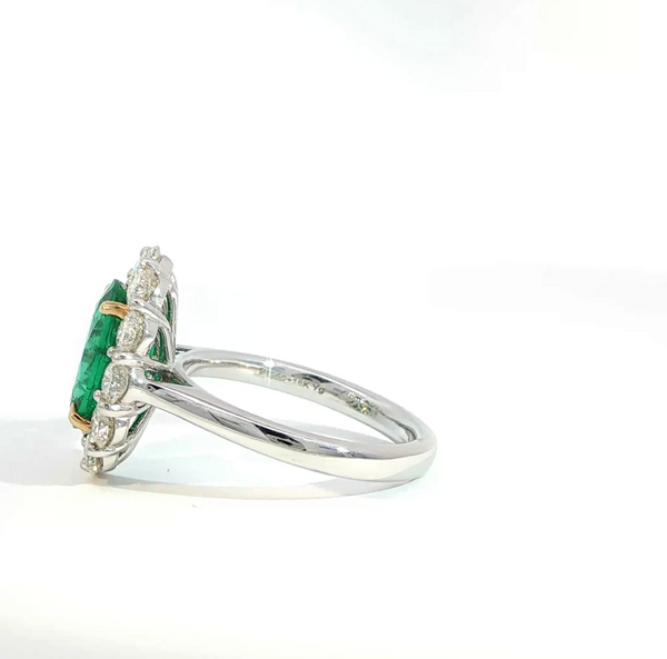 Oval Cut Emerald and Diamond Halo Engagement Ring